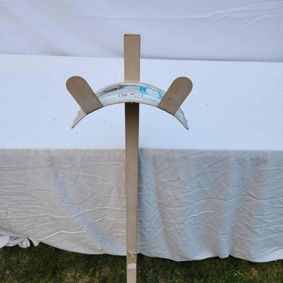 Sale Photo Thumbnail #264: Plastic lawn edging installation tool designed for securing lawn borders. Features a wooden handle and a plastic attachment for aligning and situating lawn edging materials. Label indicates compatibility with specific plastic lawn edging products. Appears