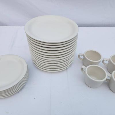 Sale Photo Thumbnail #283: 15 white ceramic restaurant-style plates, 7 matching saucers, and 4 handle-equipped coffee cups. All items are crafted for durability and are stackable, making them ideal for both commercial and home use. Uniform design ensures a cohesive look throughout 