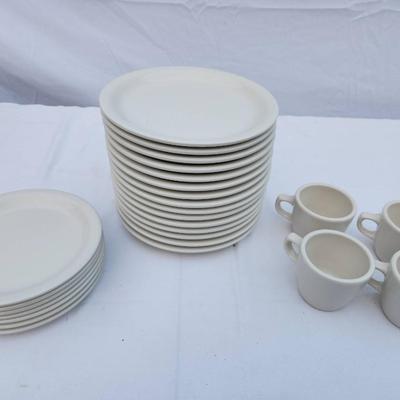 Sale Photo Thumbnail #287: 15 white ceramic restaurant-style dishes, 7 saucers, and 4 matching ceramic coffee cups. The dishes and saucers are rounded, stackable, and designed for durability and frequent use. The coffee cups are equipped with handles for easy grip, and all items fe