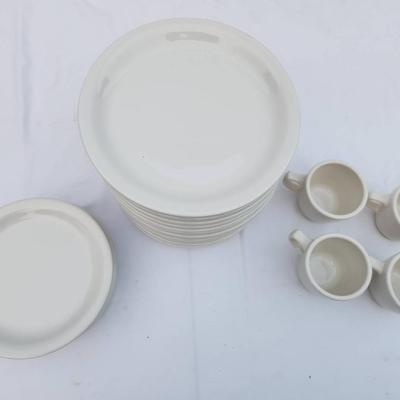 Sale Photo Thumbnail #288: 15 white ceramic restaurant-style dishes, 7 saucers, and 4 matching ceramic coffee cups. The dishes and saucers are rounded, stackable, and designed for durability and frequent use. The coffee cups are equipped with handles for easy grip, and all items fe