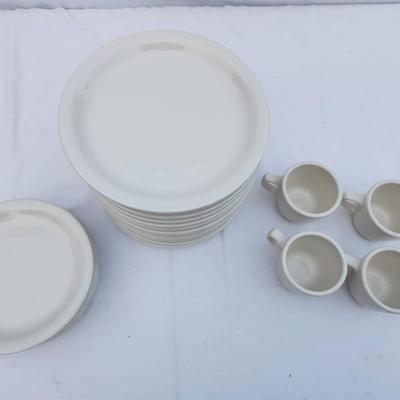 Sale Photo Thumbnail #290: 15 white ceramic restaurant-style plates, 7 white saucers, and 4 matching ceramic coffee cups. Plates and saucers are rounded and stackable, crafted for durability and regular use. Coffee cups are equipped with handles for an easy grip. Uniform design mak