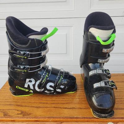 Sale Photo Thumbnail #291: Rossignol Comp J4 Ski Boots featuring a black and green design, four adjustable buckles for secure fit, and comfort-focused padding. The sole length is marked as 295 mm. Designed for junior skiers, these boots combine performance and ease of use. Pre-owne