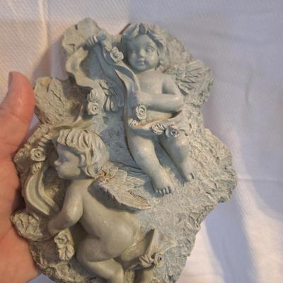 plaster or other material wall hanging with cherubs