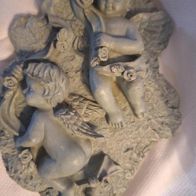 plaster or other material wall hanging with cherubs
