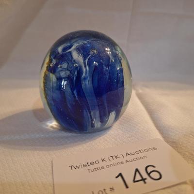 blown glass paperweight with blue swirls