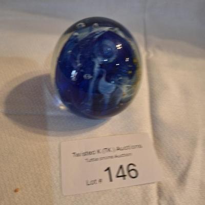 blown glass paperweight with blue swirls