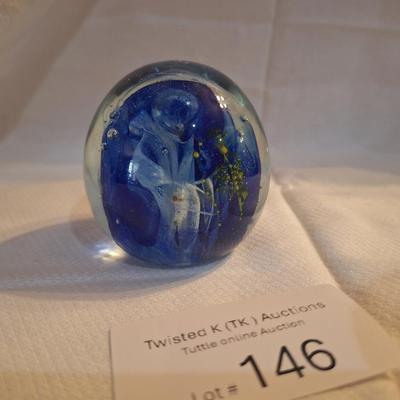 blown glass paperweight with blue swirls