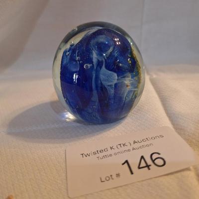 blown glass paperweight with blue swirls