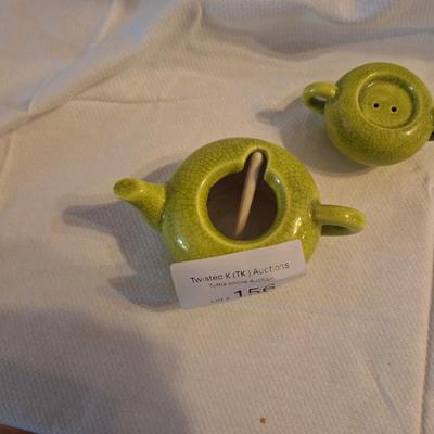 ceramic kettle the top one is a salt shaker the bottom is for something else.