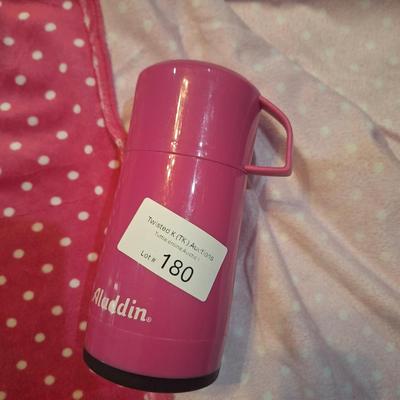 pink blanket and thermos