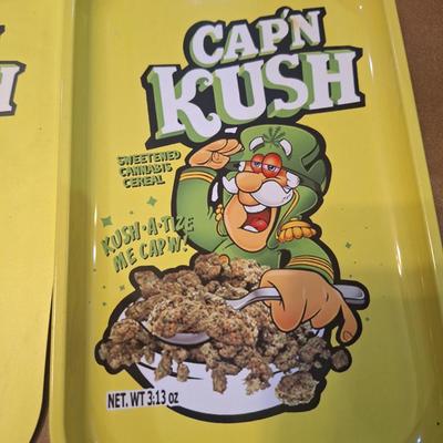 metal tray and magnetic mat of Cap'n Kuch with images of cannabis on it