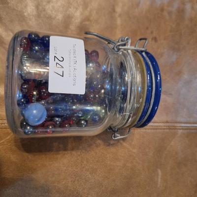 glass jar of glass beads and marbles