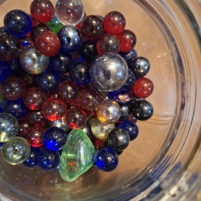 glass jar of glass beads and marbles