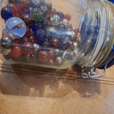 glass jar of glass beads and marbles
