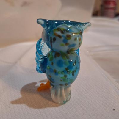 miniature glass owl, wings covering mouth