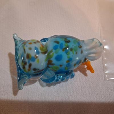 miniature glass owl, wings covering mouth