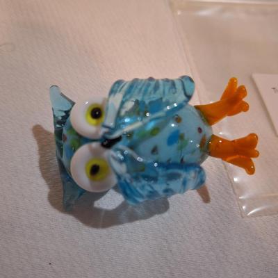 miniature glass owl, wings covering mouth