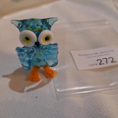 miniature glass owl, wings covering mouth