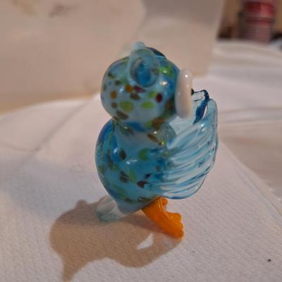 miniature glass owl, wings covering mouth