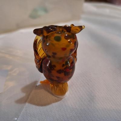 miniature blown glass owl with wings covering eyes