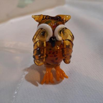 miniature blown glass owl with wings covering eyes