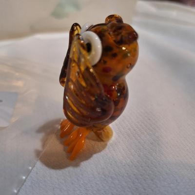 miniature blown glass owl with wings covering eyes
