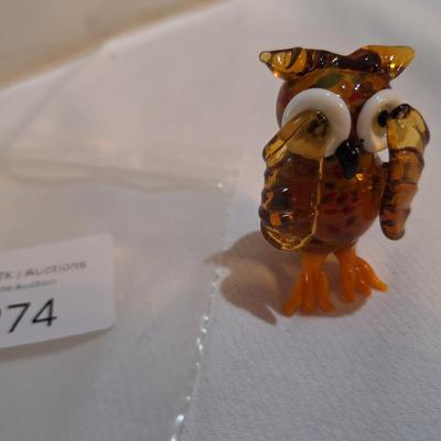 miniature blown glass owl with wings covering eyes