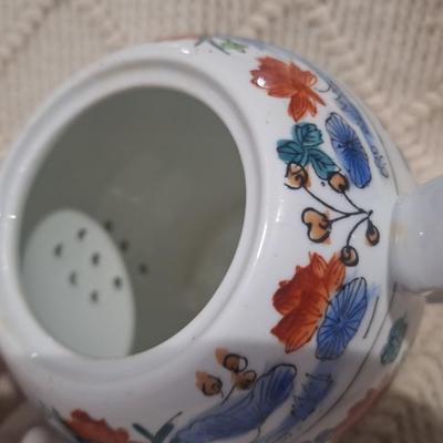 Ceramic teapot with blue and red floral design