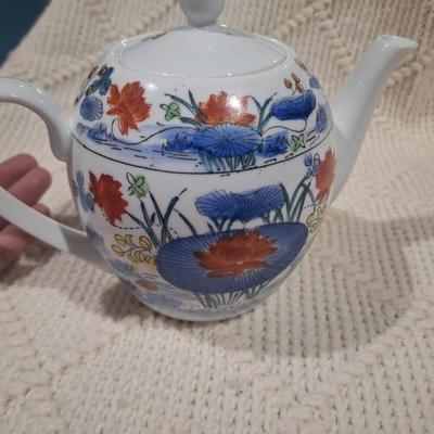 Ceramic teapot with blue and red floral design
