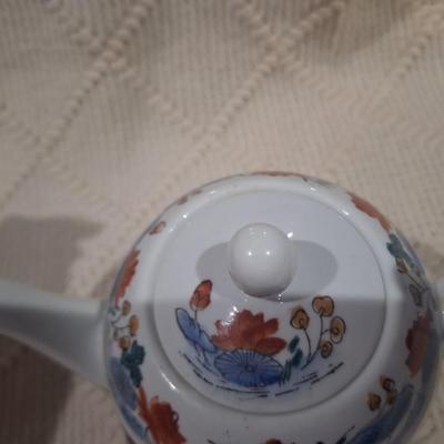 Ceramic teapot with blue and red floral design
