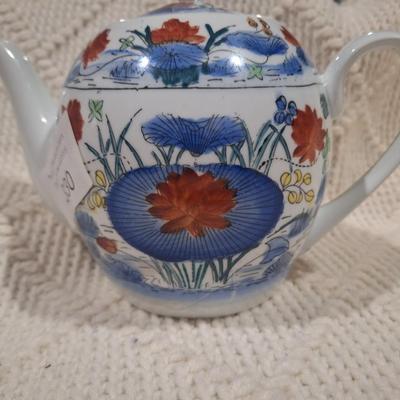 Ceramic teapot with blue and red floral design