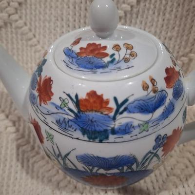 Ceramic teapot with blue and red floral design