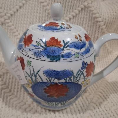 Ceramic teapot with blue and red floral design