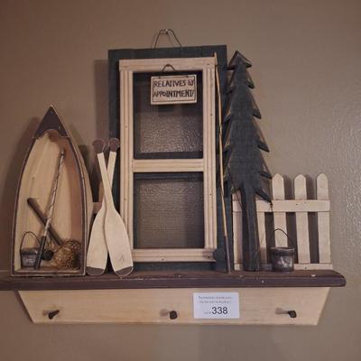Wall decor with pegs for hats or light jackets