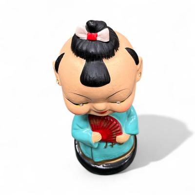 Sale Photo Thumbnail #1018: Vintage Japanese Bobblehead Figurine.  This figurine has jewel eyes and traditional attire and is characteristic of figures produced in the 1950's and early 1960's.
Approximately 6" tall