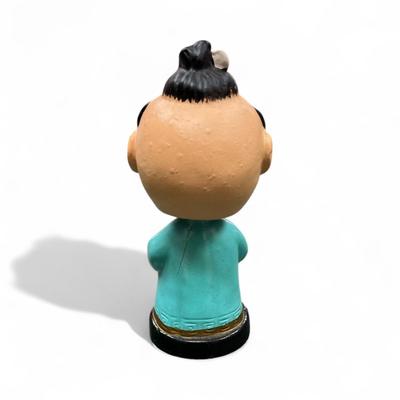 Sale Photo Thumbnail #1016: Vintage Japanese Bobblehead Figurine.  This figurine has jewel eyes and traditional attire and is characteristic of figures produced in the 1950's and early 1960's.
Approximately 6" tall