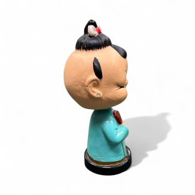 Sale Photo Thumbnail #1017: Vintage Japanese Bobblehead Figurine.  This figurine has jewel eyes and traditional attire and is characteristic of figures produced in the 1950's and early 1960's.
Approximately 6" tall