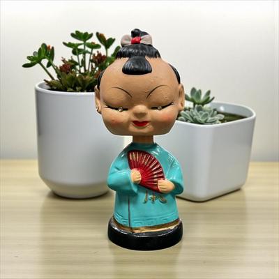 Sale Photo Thumbnail #1019: Vintage Japanese Bobblehead Figurine.  This figurine has jewel eyes and traditional attire and is characteristic of figures produced in the 1950's and early 1960's.
Approximately 6" tall