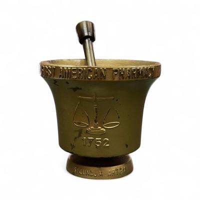 Sale Photo Thumbnail #1060: Vintage Schering Mortar and Pestle Set.  The set specifically a replica commemorating the First American Pharmacy established in 1752.
Approximately 4" Tall