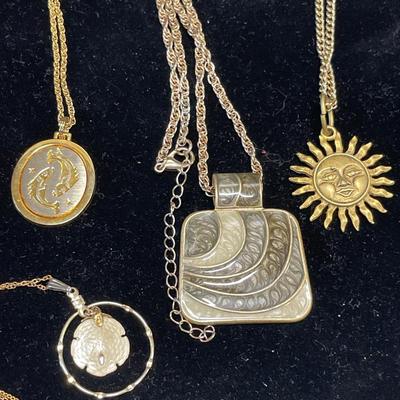 4 gold tone pendants