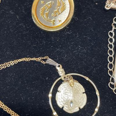 4 gold tone pendants