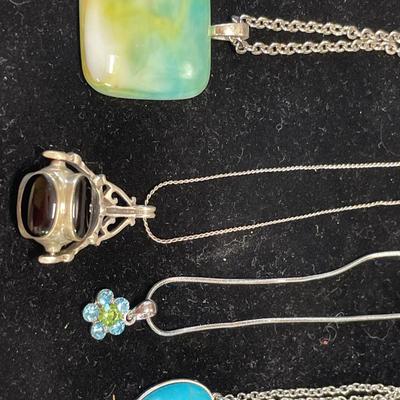 4 silver tone necklaces with pendants
