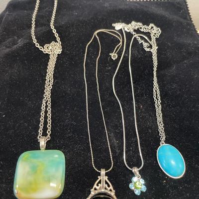 4 silver tone necklaces with pendants