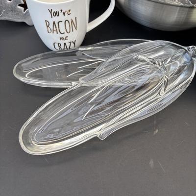 LOT 262: Hoffritz Stainless Steel Bowl, Pig Trivets, Corn on the Cob Dishes, Pig Corn Holders, Rae & Dunn Storage Jar,...