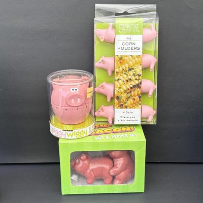 LOT 262: Hoffritz Stainless Steel Bowl, Pig Trivets, Corn on the Cob Dishes, Pig Corn Holders, Rae & Dunn Storage Jar,...