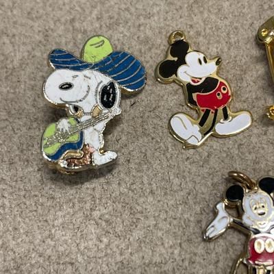 Small Disney trinkets and 1 Snoopy pin