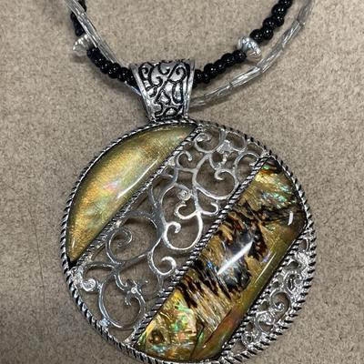 Large pendant necklaces and black and clear checkered brooch