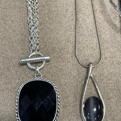 Large pendant necklaces and black and clear checkered brooch