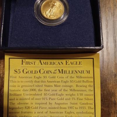Sale Photo Thumbnail #1: In Display box. Says First American Eagle. $5.00 Gold Coin of the Millennium. 91% pure gold.