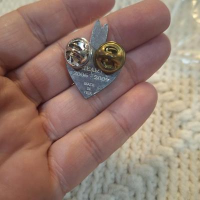 Sale Photo Thumbnail #72: Vintage enamel lapel pin featuring a heart with a bison and feathers